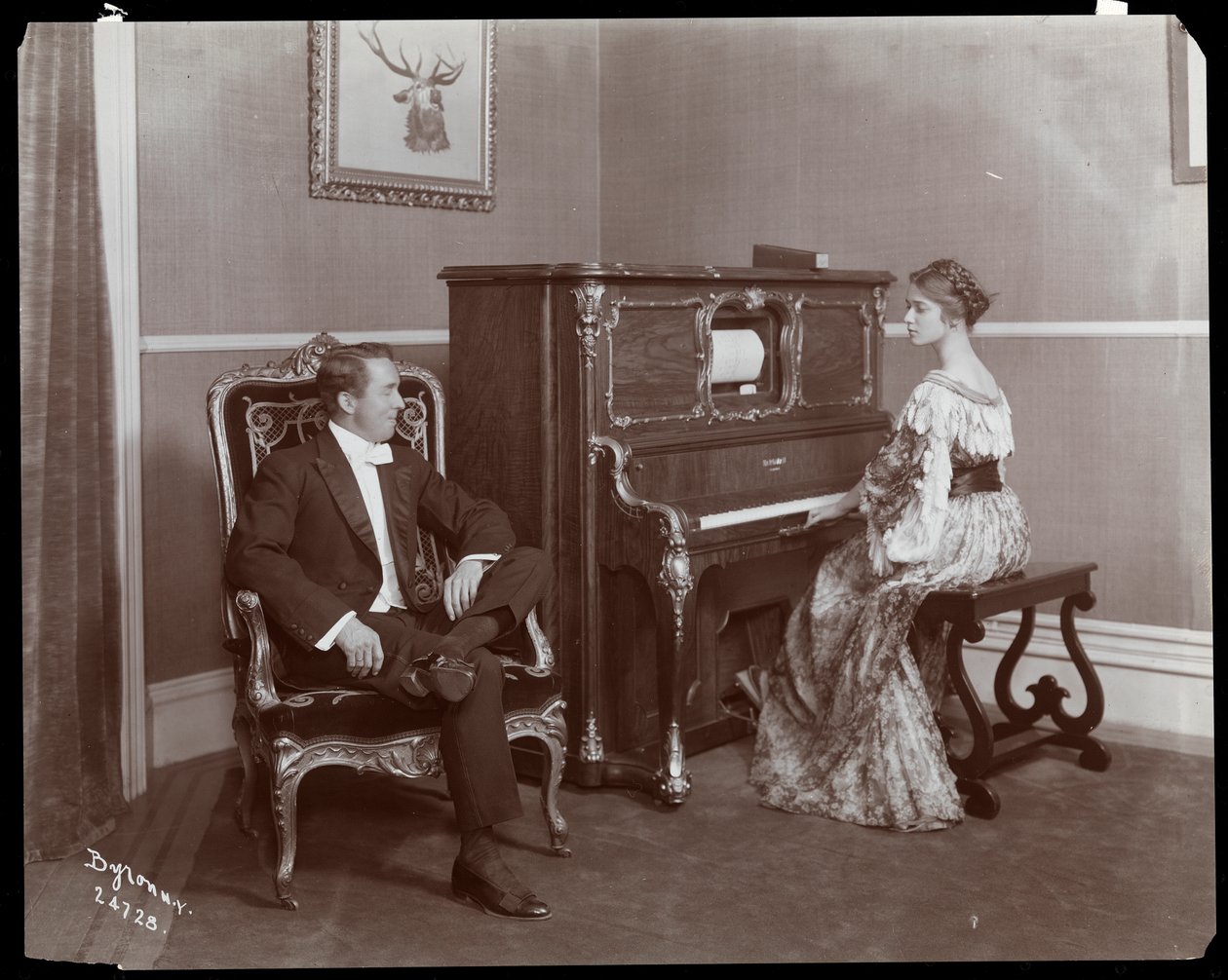 Man and woman playing a player piano, New York, 1907 by Byron Company