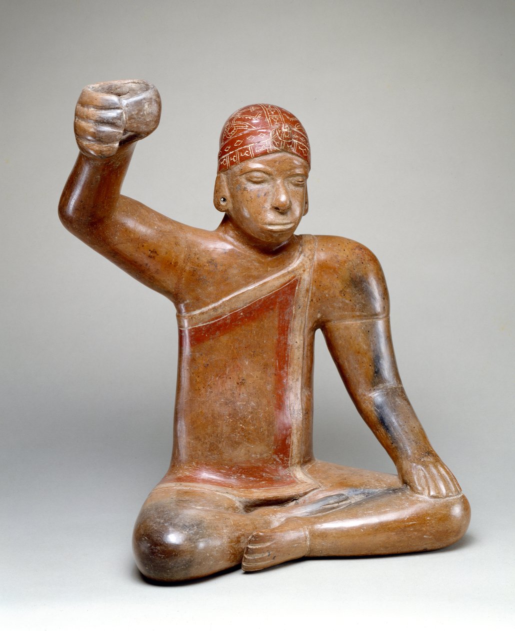 Seated Male with Raised Arm by Colima Culture