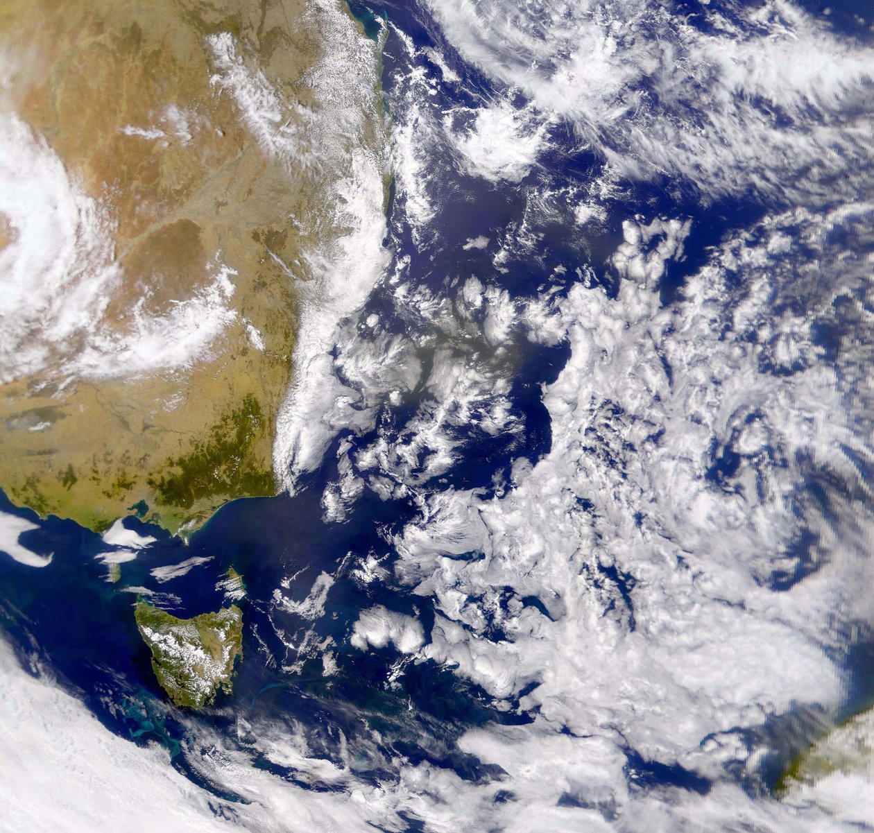 Satellite photograph of the Tasman Sea partially covered by cloud by National Aeronautics and Space Administration National Aeronautics and Space Administration