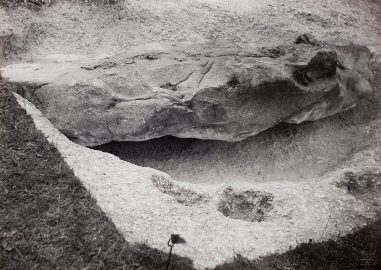 Rock recessed in grass by Paul Nash
