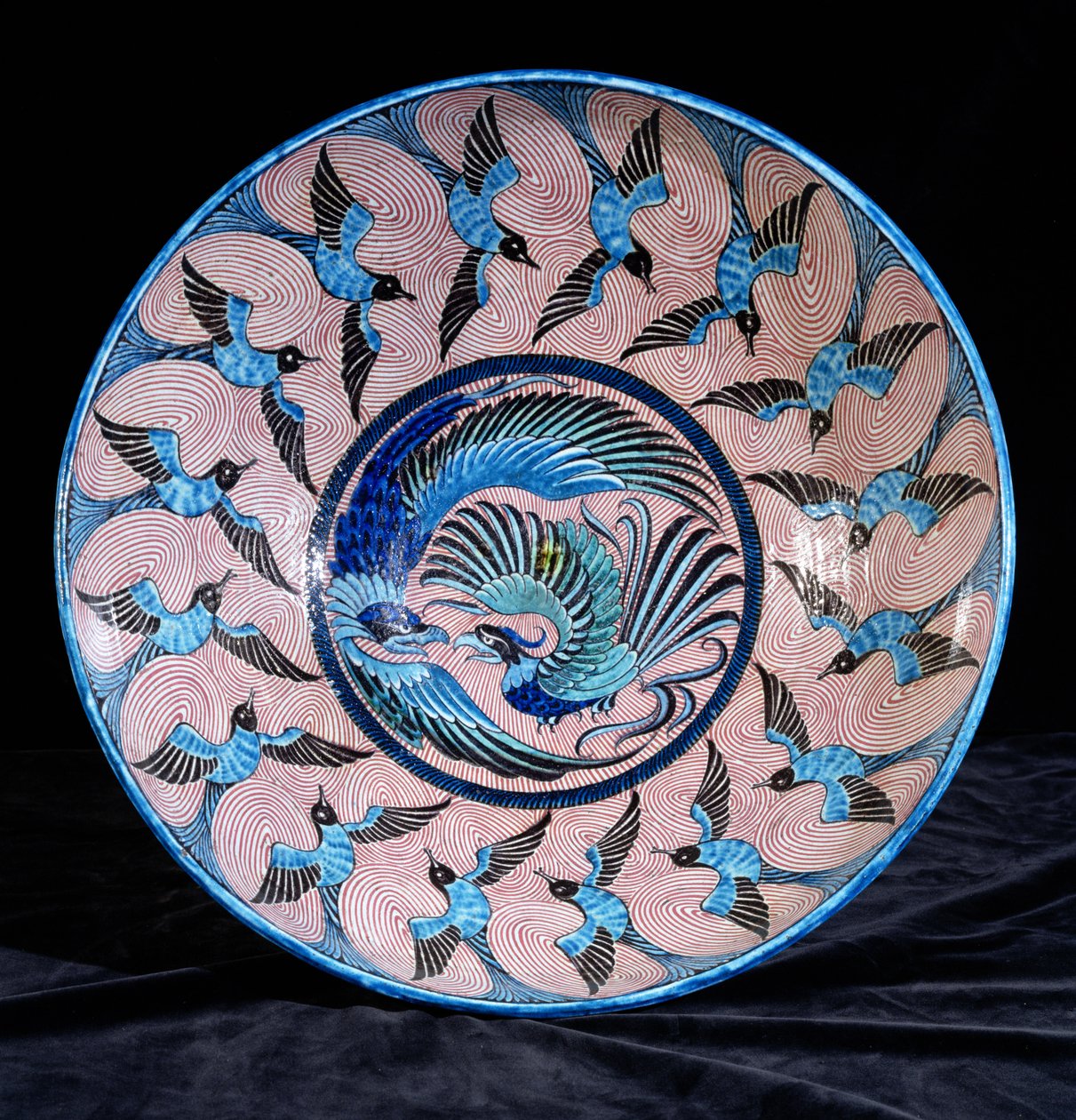 Deep punch bowl, with two eagles in the centre surrounded by swallows by William de Morgan