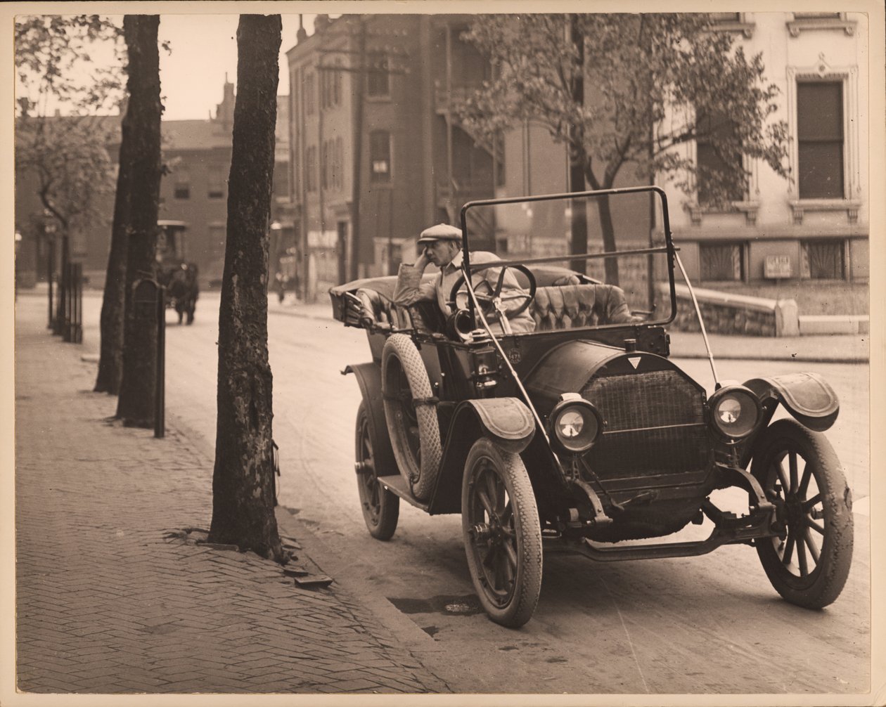 Man Seated in Automobile on Unidentified Street by William G. Swekosky