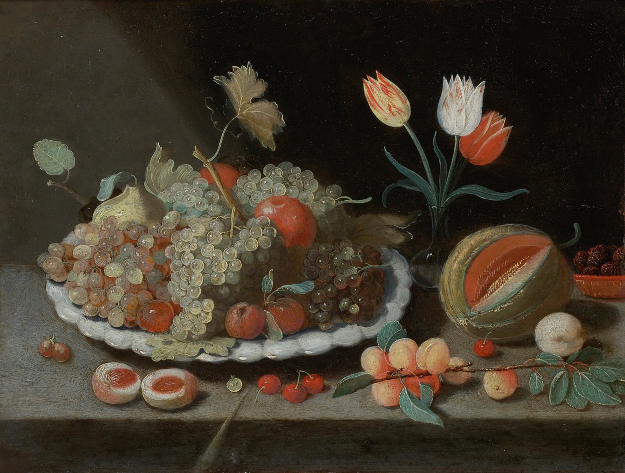 Still Life with Grapes and Other Fruit on a Platter, a Glass Vase with Tulips, a Melon, Apricots, Cherries and Other Fruits, All on a Ledge by Workshop of Jan van Kessel the Elder