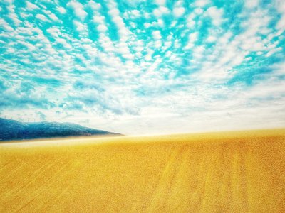 Surreal Desert Beach in Mountain Range by Katha Wood