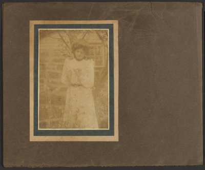 Woman Holding Flower in Garden by Louis Fleckenstein