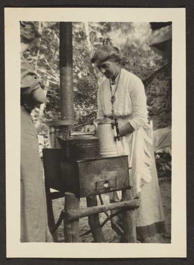 Woman Using Outdoor Stove by Louis Fleckenstein