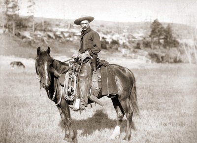 A cowboy on horseback by Unknown photographer